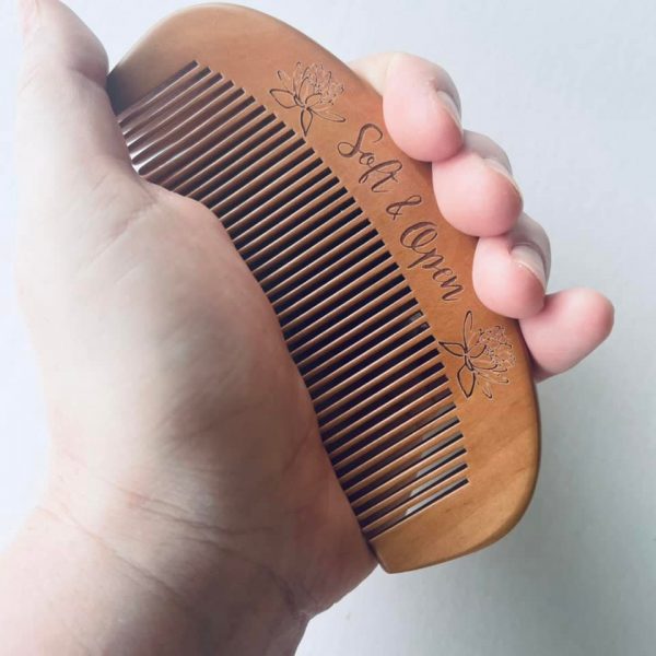 holding wooden birth comb